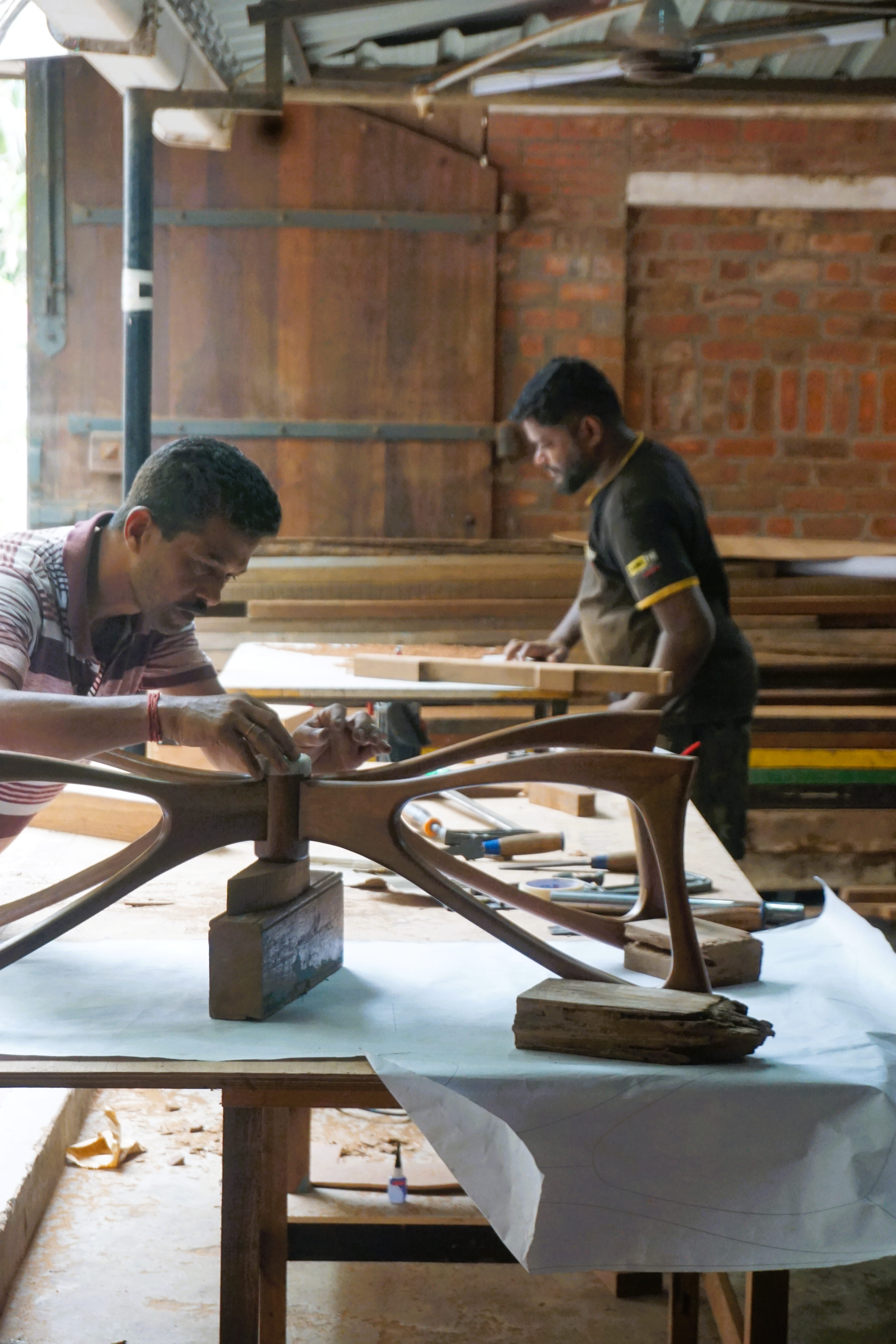 Master carpenter cutting solid wood for a custom furniture frame